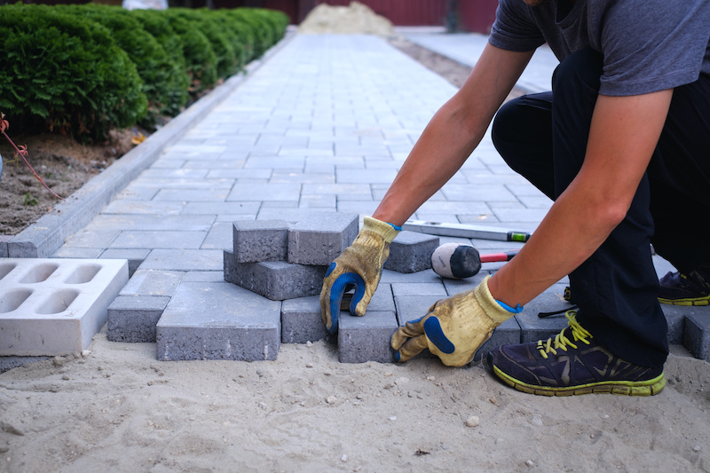 man laying pavers