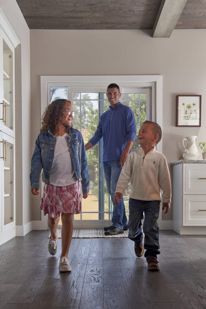 family walking into home